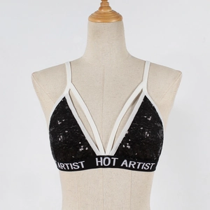 Detail view of black sequined bra with white crisscross straps and HOT ARTIST elastic band