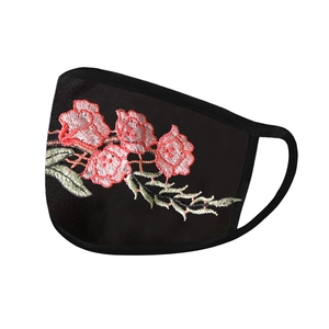 Detail of floral embroidery on breathable black sun-protection fabric mask