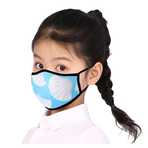 Close-up of a blue breathable child face mask with shell print and black piping edge