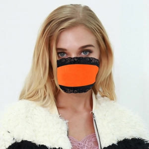 Close-up of vibrant orange sun protection face mask with black lace trim on a model