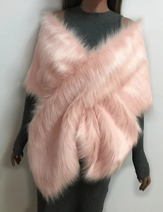 Detail of soft pink faux fur texture and cross-over design on a luxury bridal shawl
