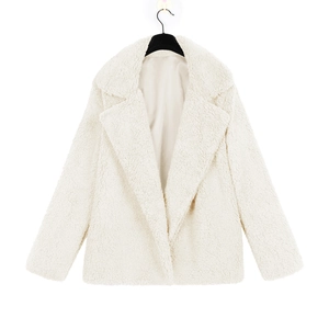 Detail view of plush white faux fur teddy coat with wide lapels and smooth inner lining