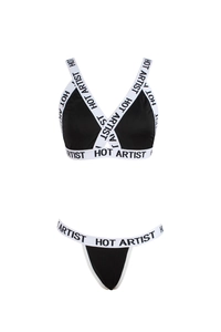 Close-up of black and white lingerie set with HOT ARTIST lettered elastic bands