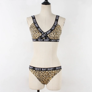 Detail of leopard print lingerie set with SE-XY BABY text on elastic bands and V-neckline