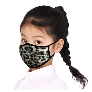 Close-up of leopard print face mask on a young girl showing the soft fabric and ear loops