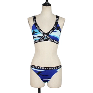 Detail of blue camo bikini set with SE-XY BABY elastic bands on mannequin