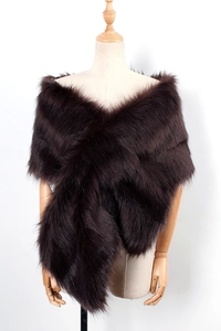 Close-up detail of dark brown faux fox fur shawl with cross-style wrap on a wooden mannequin