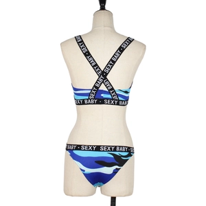 Detail of blue camo bikini with cross-back straps and Sexy Baby lettered elastic bands