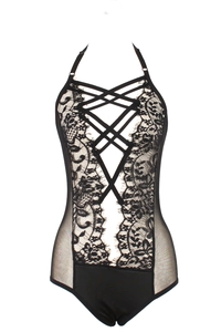 Macro detail of intricate black floral lace and mesh paneling on a sexy halter bodysuit