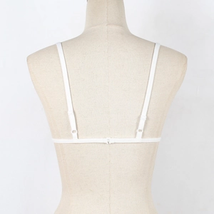 Detail view of white lace bra back with thin adjustable straps and plastic hook closure