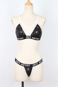 Detail of black sequin lingerie set with HOT ARTIST lettered elastic bands
