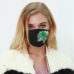 Washable sun-protective black face mask with elegant green and gold floral embroidery