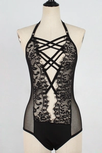 Detail of black lace bodysuit featuring halter neck and intricate cross-strap chest design