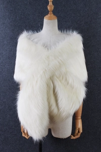 Detail of white faux fur shawl with a cross-over design for winter bridal evening wear