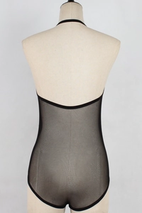 Detail of sheer black mesh bodysuit with backless design and transparent fabric texture