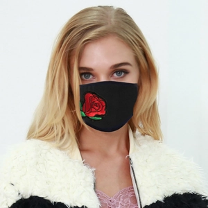 Washable black protective face mask with red rose embroidery on a female model