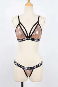 Detail of rose gold sequin bikini set with black elastic HOT ARTIST logo straps