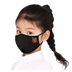 Close-up of a child wearing a black breathable mask with red apple embroidery detail