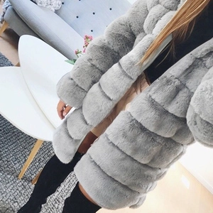 Detail of grey faux fur coat with horizontal stitching and layered plush texture