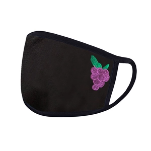 Detailed close-up of a black washable fabric mask with purple grape embroidery detail