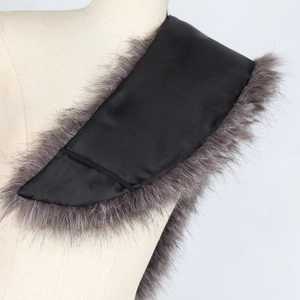 Detail view of a dark gray faux fur shawl collar with a smooth black satin lining on a mannequin