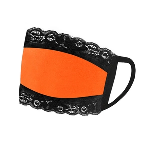 Detailed close-up of breathable bright orange fabric mask with black floral lace trim