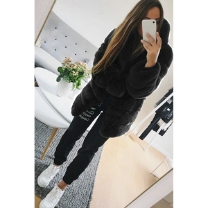 Close-up of fluffy black faux fur coat texture with hooded design and soft long sleeves