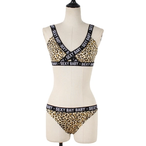Women's leopard print lingerie set with sexy baby letter straps on white mannequin