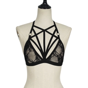 Macro shot of black lace cage bra with geometric strappy details and metallic rings
