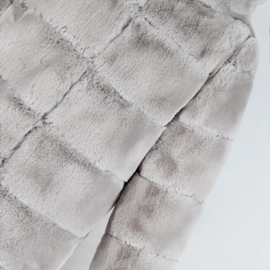 Detail shot of light grey faux fur coat showing square quilted texture and soft plush seams