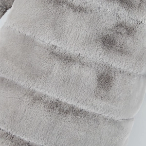 Detail view of plush grey faux fur fabric with elegant diagonal striped stitching texture