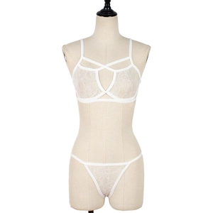 Detailed view of white floral lace lingerie set with strappy details on mannequin