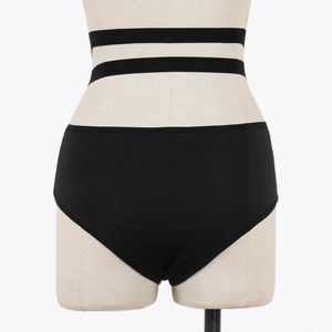 Detail of high waisted black panties with cut-out elastic straps on a mannequin