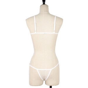 Detailed back view of white lace lingerie set with thong and minimalist straps on mannequin