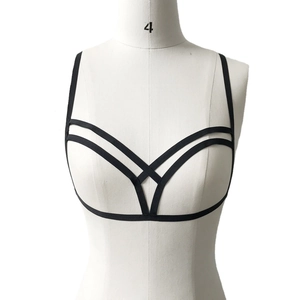 Front view of black elastic cage bra body chain with geometric cross design on a white mannequin