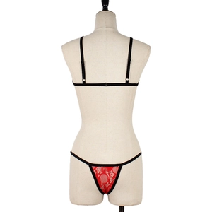 Detail view of red floral lace lingerie set with black straps on a mannequin back
