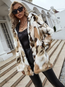 Macro shot of faux fur coat texture featuring white and brown contrast square patterns