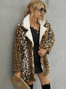 Detail of faux fur leopard print coat with white shearling collar in a street style look