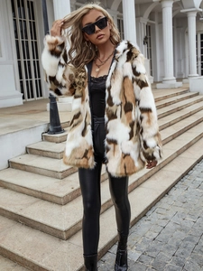 Close-up of color-block faux fur coat texture with white and brown patchwork design