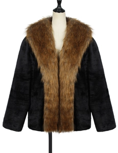 Detail of faux fur coat featuring luxurious black plush body and brown oversized lapel