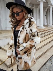 Detail showing plush texture of long faux fur coat with contrast color block pattern