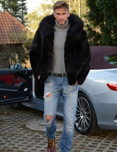 Detail of men's hooded faux fox fur coat in black with thick luxury plush texture