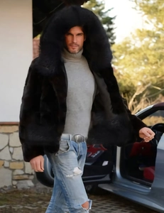 Detail view of men's faux fox fur coat with hood in deep black luxury winter style