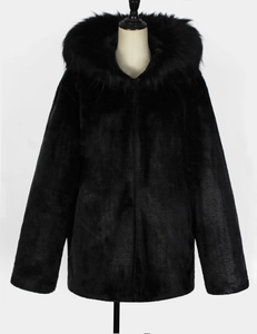 Detail view of premium black faux fur coat with thick hood and soft textured lining