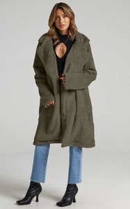 Detail view of women's olive green oversized faux fur coat with plush texture and wide collar