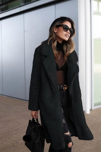 Macro detail of black faux fur teddy coat texture with classic wide lapel collar