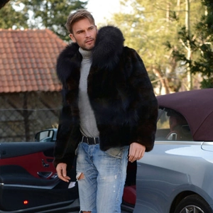 Luxurious faux fox fur jacket for men featuring a thick collar beside a silver sports car