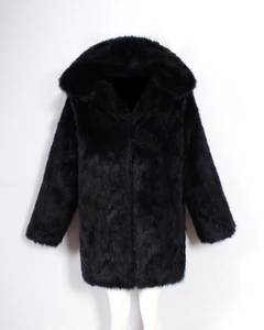 Detail of luxurious black faux fur coat showing thick texture and glossy hooded finish