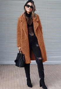 Detail of caramel teddy fleece texture on long sleeve winter coat with lapel collar