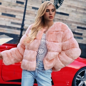 Detailed close-up of pink faux fur jacket with horizontal stripes and white graphic tee